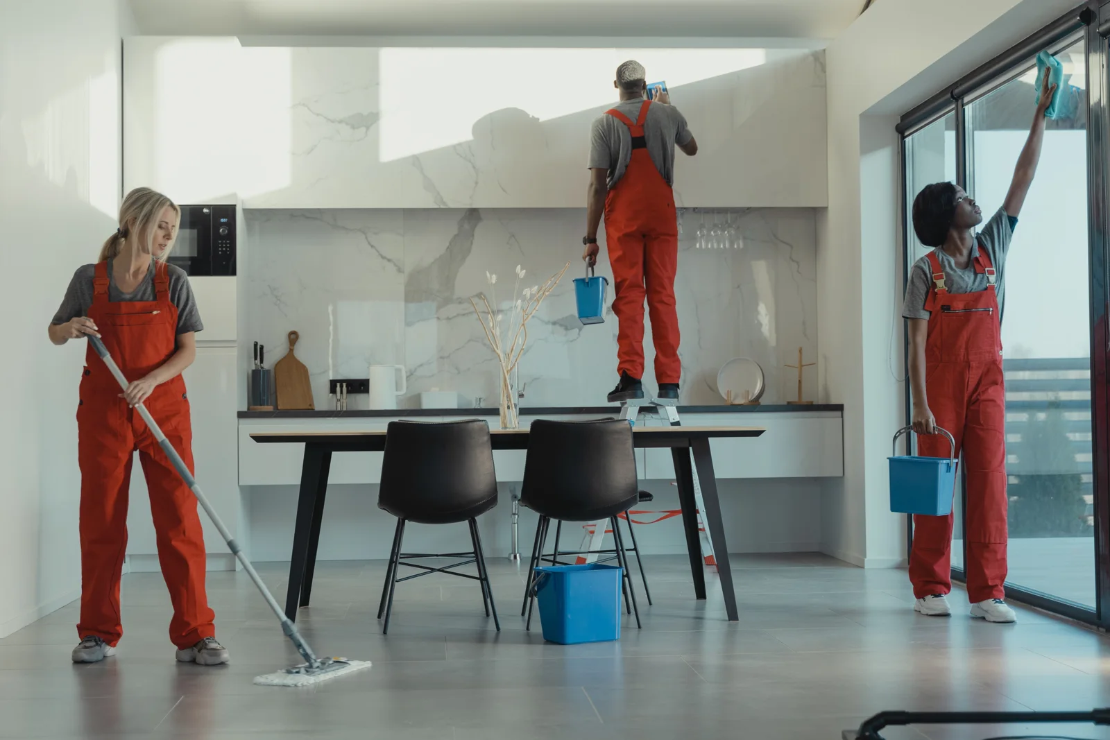 Cleaning professionals refreshing a modern kitchen
